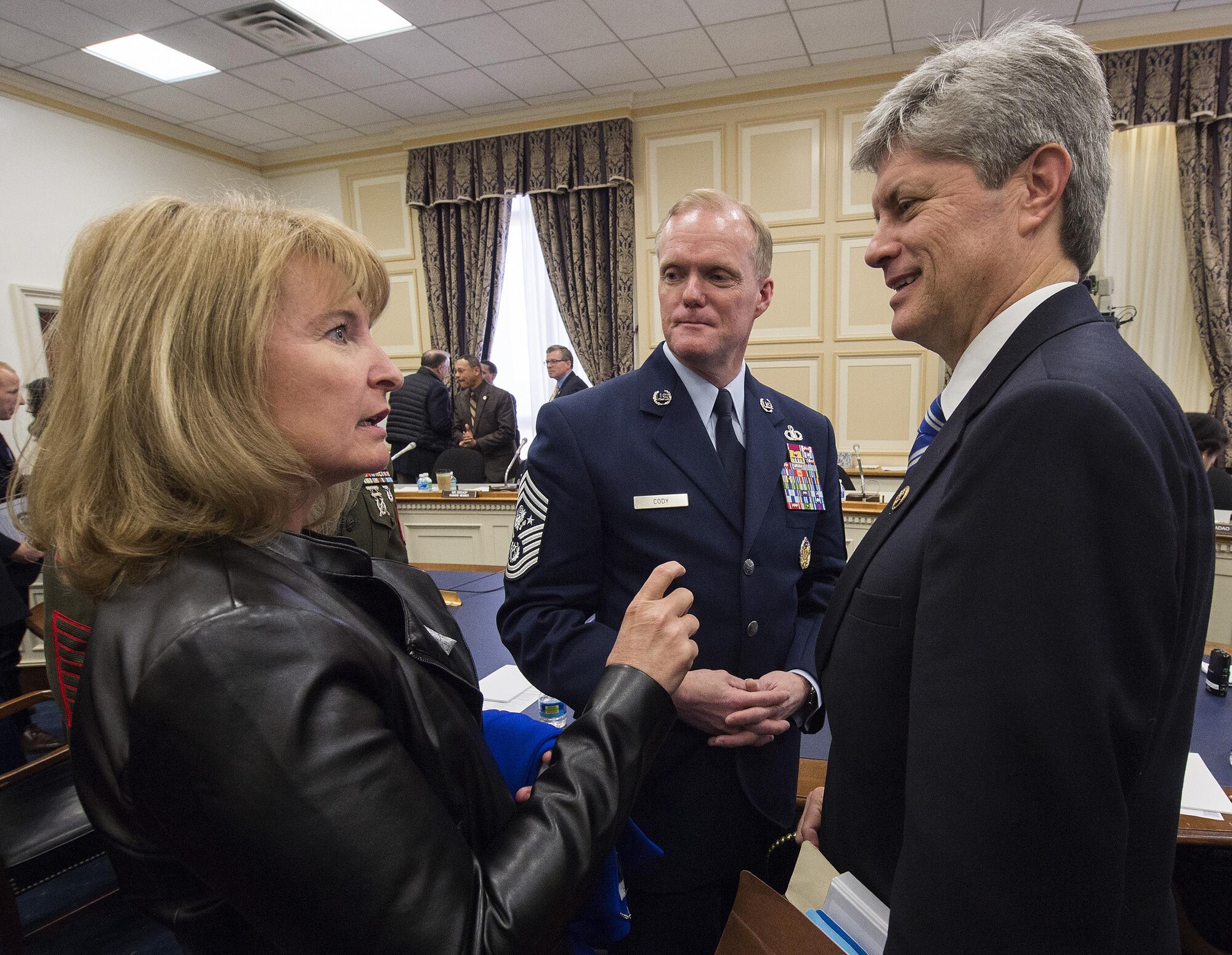 Chief Master Sgt. of the Air Force James A. Cody, and his wife Athena Cody, talk with Rep. Jeff Fortenberry(R-Neb.) following a hearing of the House Appropriations Committee’s Subcommittee on Military Construction and Veterans Affairs Feb. 26, 2016, in Washington, D.C. Fortenberry is vice chair of the subcommittee. The oversight hearing was being held to learn about quality of life in the military concerns from each of the service's senior most enlisted members. During his opening statement Cody stressed the cumulative impacts of sequestered and reduced budgets on the compensation and quality of life of Airmen and their families. Cody stressed that the Airmen who serve today do so freely, proudly and voluntarily because they believe in what America stands for and are ready to defend its cause. He added that our nation must honor that commitment by providing for them and their families. (U.S. Air Force photo/Jim Varhegyi)