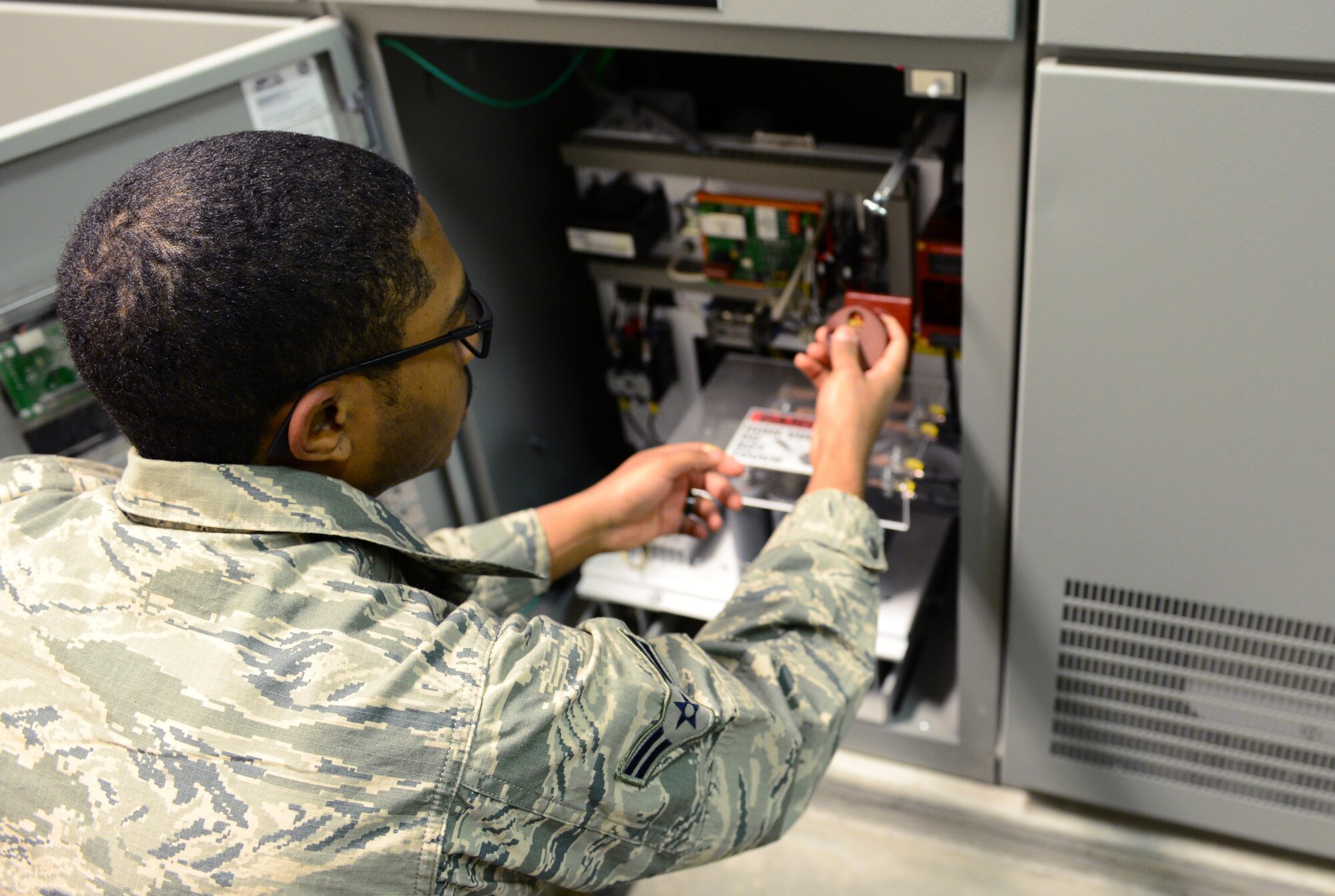 U.S Air Force Airman 1st Class Anthony Cooper, a 354th Civil Engineer Squadron electrical systems apprentice, works in a test switch Feb. 8, 2016, at Eielson Air Force Base, Alaska. The test switch is in the airfield vault, where electricity for the airfield starts and ends. (U.S Air Force photo by Airman 1st Class Cassandra Whitman/Released)