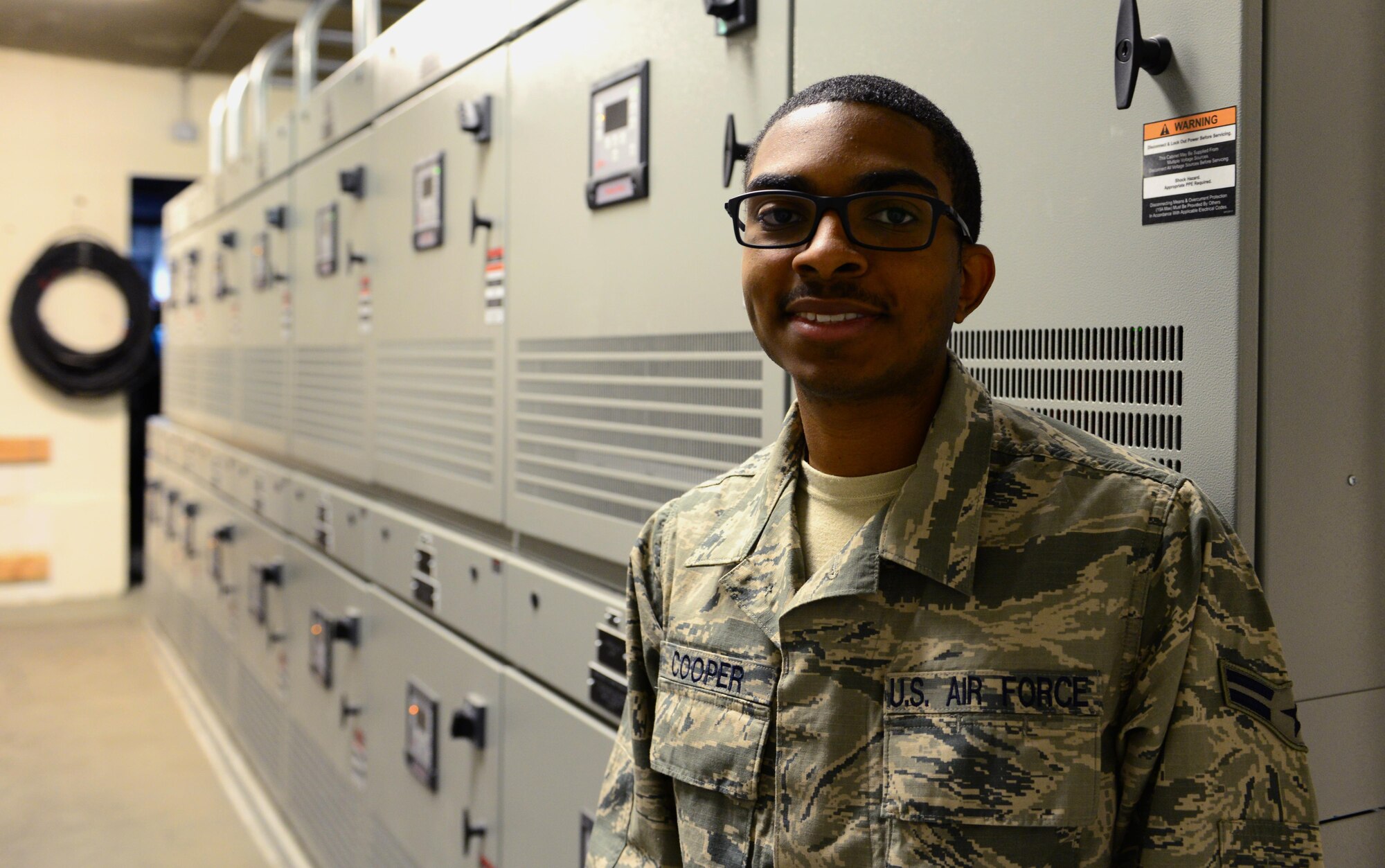 U.S. Air Force Airman 1st Class Anthony Cooper, a 354th Civil Engineer Squadron electrical systems apprentice, pauses for a photo Feb. 8, 2016, at Eielson Air Force Base, Alaska. Cooper stands in the airfield vault, where electricity for the airfield starts and ends. (U.S. Air Force photo by Airman 1st Class Cassandra Whitman/Released