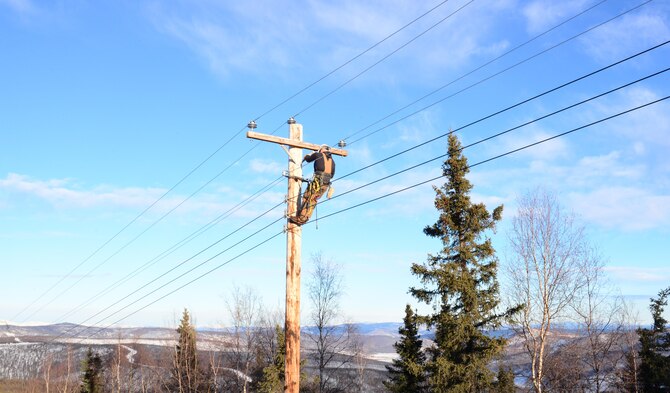 U.S. Air Force Senior Airman Travis Bothast, a 354th Civil Engineer Squadron electrical systems journeyman, works on a utility pole Feb. 5, 2016, at Eielson Air Force Base, Alaska. Bothast works on the exterior side of electrical systems, maintaining streetlights, utility poles and the Yukon Training Range. (U.S. Air Force photo by Airman 1st Class Cassandra Whitman/Released)