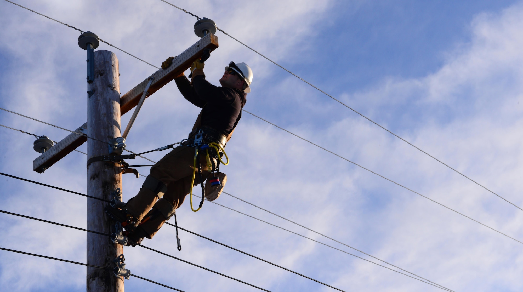 U.S. Air Force Senior Airman Travis Bothast, a 354th Civil Engineer Squadron electrical systems journeyman, works on a utility pole Feb. 5, 2016, at Eielson Air Force Base, Alaska. Bothast works on the exterior side of electrical systems, maintaining streetlights, utility poles and the Yukon Training Range. (U.S. Air Force photo by Airman 1st Class Cassandra Whitman/Released)