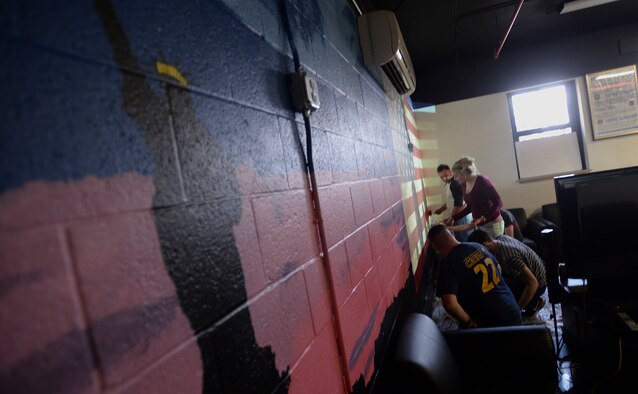 Members of the Airman Ministry Center, or the “Den”, paint a mural on the interior walls of the room, Feb. 13, 2016, at McConnell Air Force Base, Kan. The mural was started on Feb. 6 and is set to be finished the first week of March. (U.S. Air Force photo/Senior Airman Colby L. Hardin)