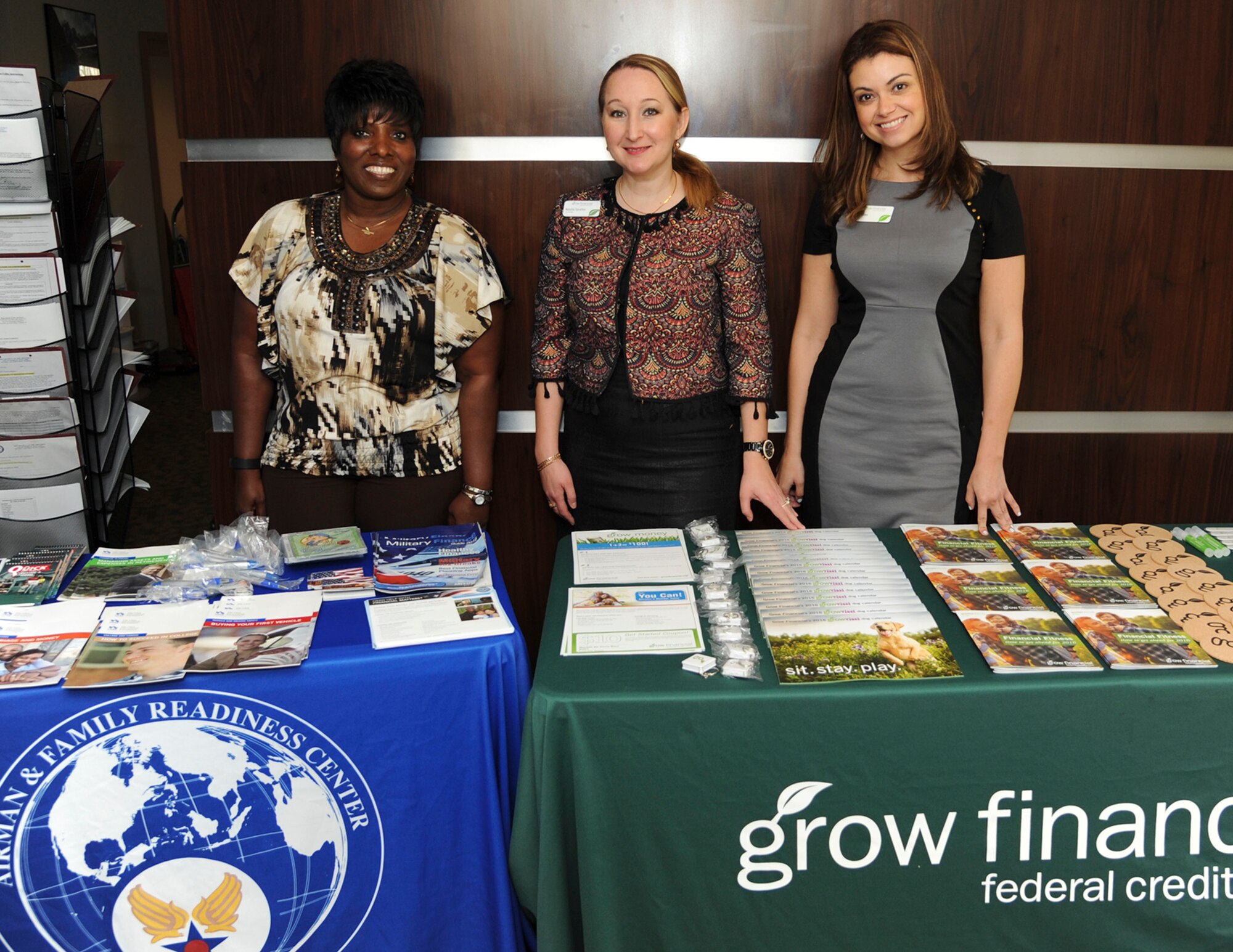 Airman & Family Readiness Center and Grow Financial Federal Credit Union representatives display financial resources on a table during Military Saves Week in the Airman Dorm Leader Office at MacDill Air Force Base, Fla., Feb. 23, 2016. Since 2007, the Department of Defense has designated the last week of February as Military Saves Week to motivate Service members and their families to save money, reduce debt and build wealth. (U.S. Air Force photo by Senior Airman Danielle Quilla)
