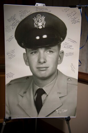 A photo of a young Frank Metzger, a Wing Plans program analyst with the 437th Airlift Wing, was signed by his friends, family and coworkers during his retirement ceremony recognizing 54 years of combined federal service, Feb. 23, 2016, at Joint Base Charleston, S.C. Metzger served in the military as a navigator for 24 years and a civil servant for 30 years. His first assignment was with the 1608th Air Transport Wing at Charleston Air Force Base. (U.S. Air Force photo/Staff Sgt. Jared Trimarchi)