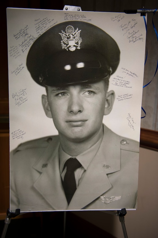 A photo of a young Frank Metzger, a Wing Plans program analyst with the 437th Airlift Wing, was signed by his friends, family and coworkers during his retirement ceremony recognizing 54 years of combined federal service, Feb. 23, 2016, at Joint Base Charleston, S.C. Metzger served in the military as a navigator for 24 years and a civil servant for 30 years. His first assignment was with the 1608th Air Transport Wing at Charleston Air Force Base. (U.S. Air Force photo/Staff Sgt. Jared Trimarchi)