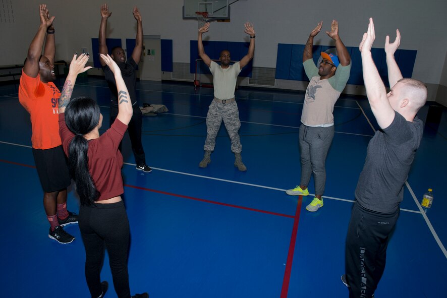 Airmen and their families participate in the African American Heritage Committee’s fitness challenge at Minot Air Force Base, N.D., Feb. 20, 2016. The fitness challenge consisted of exercises such as jumping jacks, squats, pushups, planks and burpees. (U.S. Air Force photo/ Senior Airman Sahara L. Fales)