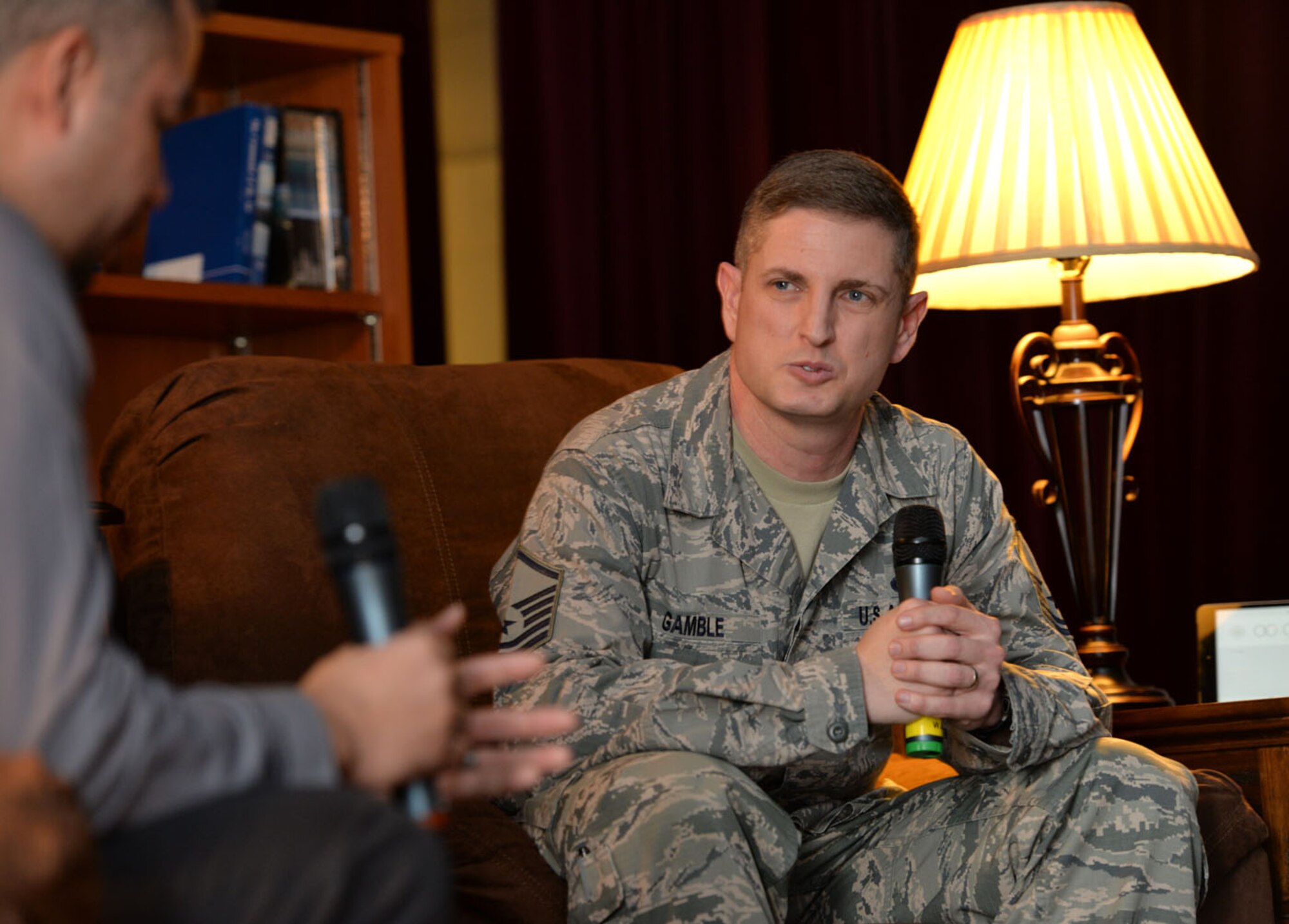U.S. Air Force Master Sgt. Jason Gamble, right, 100th Aircraft Maintenance Squadron production expediter, talks to U.S. Air Force Staff Sgt. Brandon Harris, 100th Maintenance Squadron AGE craftsman, as he shares his personal story about dealing with the loss of his parents Feb. 22, 2016, at the “Storytellers” event on RAF Mildenhall, England. The motto of Storytellers is, “Every Airman has a story,” and is an avenue for Airmen to share their stories with others. (U.S. Air Force photo by Karen Abeyasekere)