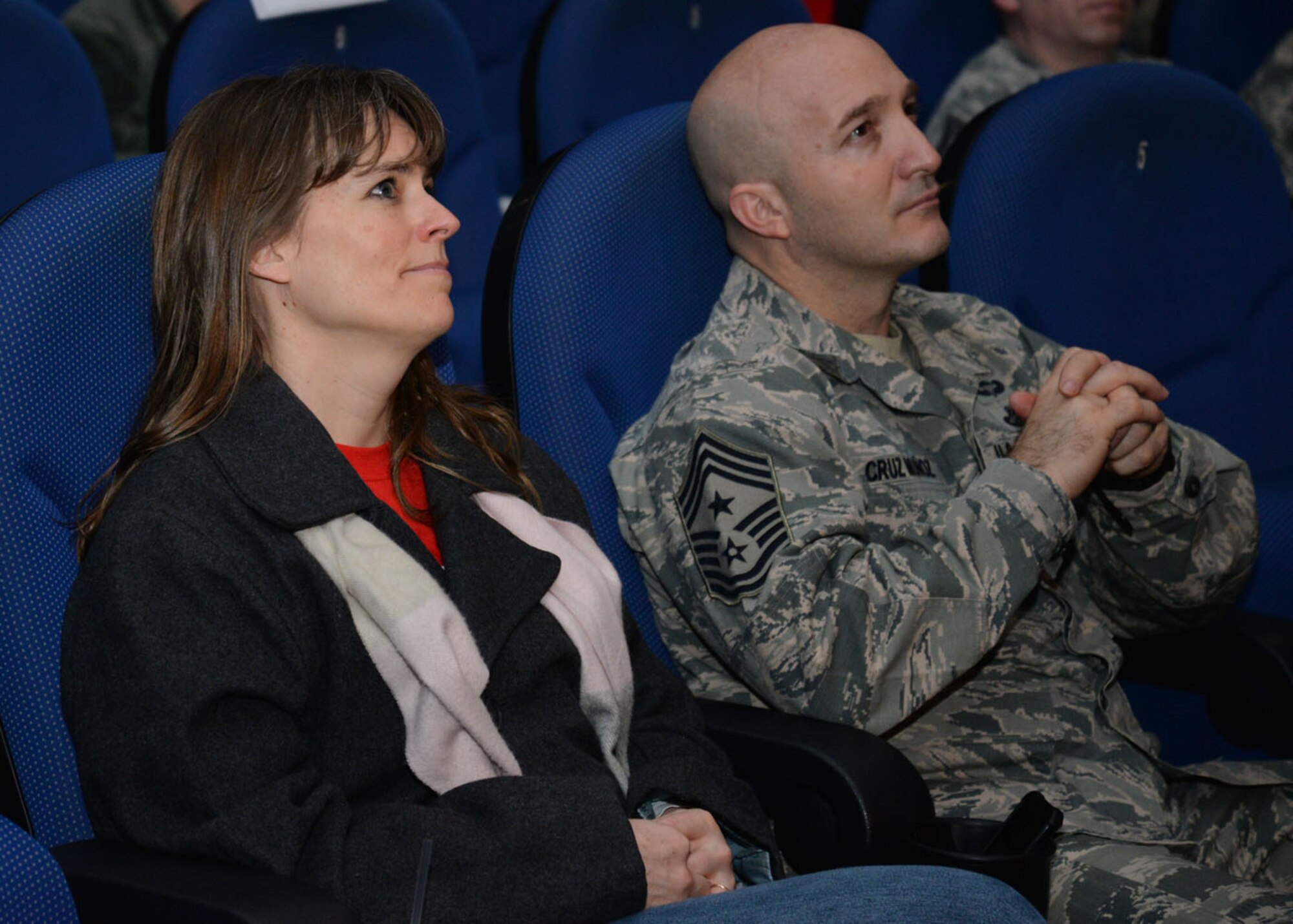 Debbie Torkelson, left, wife of U.S. Air Force Col. Thomas D. Torkelson, 100th Air Refueling Wing commander, looks at her husband as he shares his personal story of former struggles with alcohol with Team Mildenhall Airmen Feb. 22, 2016, at the “Storytellers” event on RAF Mildenhall, England. The commander shared how he hasn’t had a drink since January 2004. The motto of Storytellers is, “Every Airman has a story” and the event is an avenue for them to share their stories with others. (U.S. Air Force photo by Karen Abeyasekere)