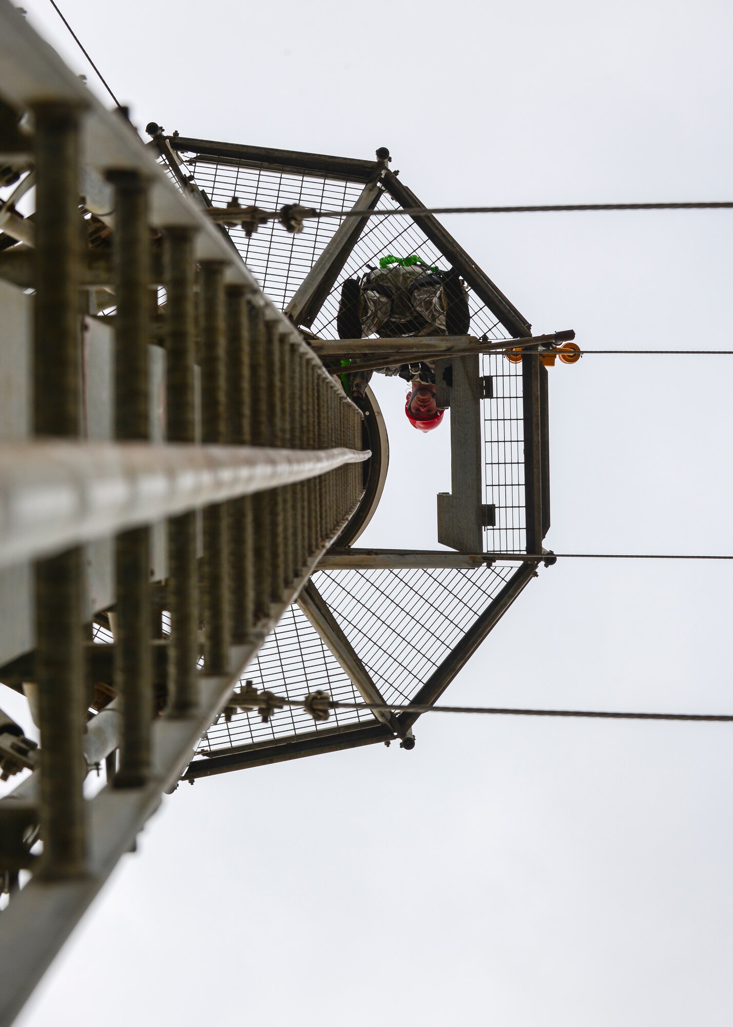Senior Airman Nathaniel Wilson, 31st Operations Support Squadron airfield systems maintenance journeyman, prepares to climb down a Tactical Air Navigation System ladder, Feb. 22, 2016, at Aviano Air Base Italy. These Airmen install and maintain more than 82 radio, navigation and meteorological systems on the flightline. (U.S. Air Force photo by Airman 1st Class Cory W. Bush/Released)