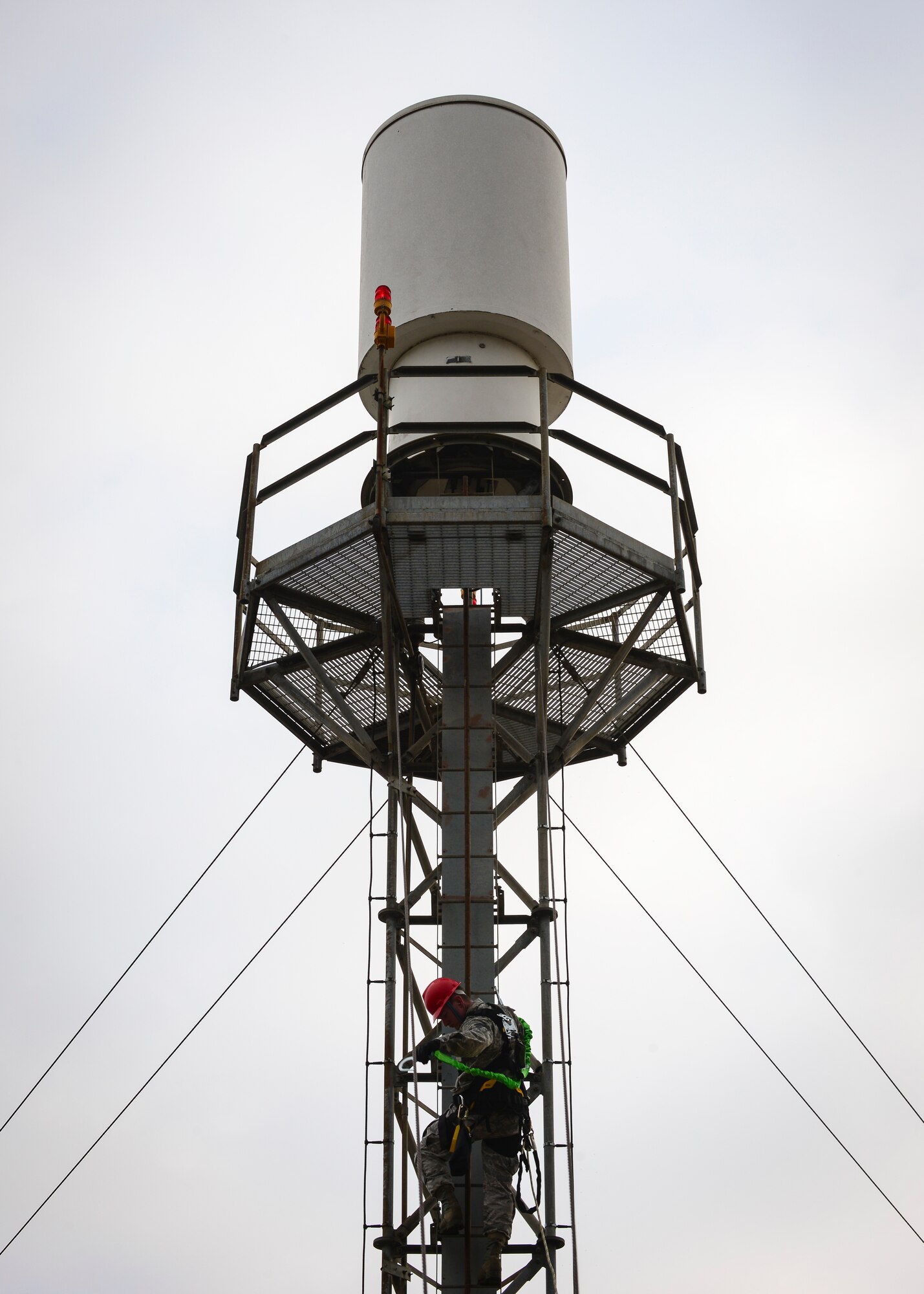 Senior Airman Nathaniel Wilson, 31st Operations Support Squadron airfield systems maintenance journeyman, climbs a Tactical Air Navigation System, Feb. 22, 2016, at Aviano Air Base Italy. A TACAN is a system that provides bearing and distance dimensions to pilot’s approaching the runway. (U.S. Air Force photo by Airman 1st Class Cory W. Bush/Released)
