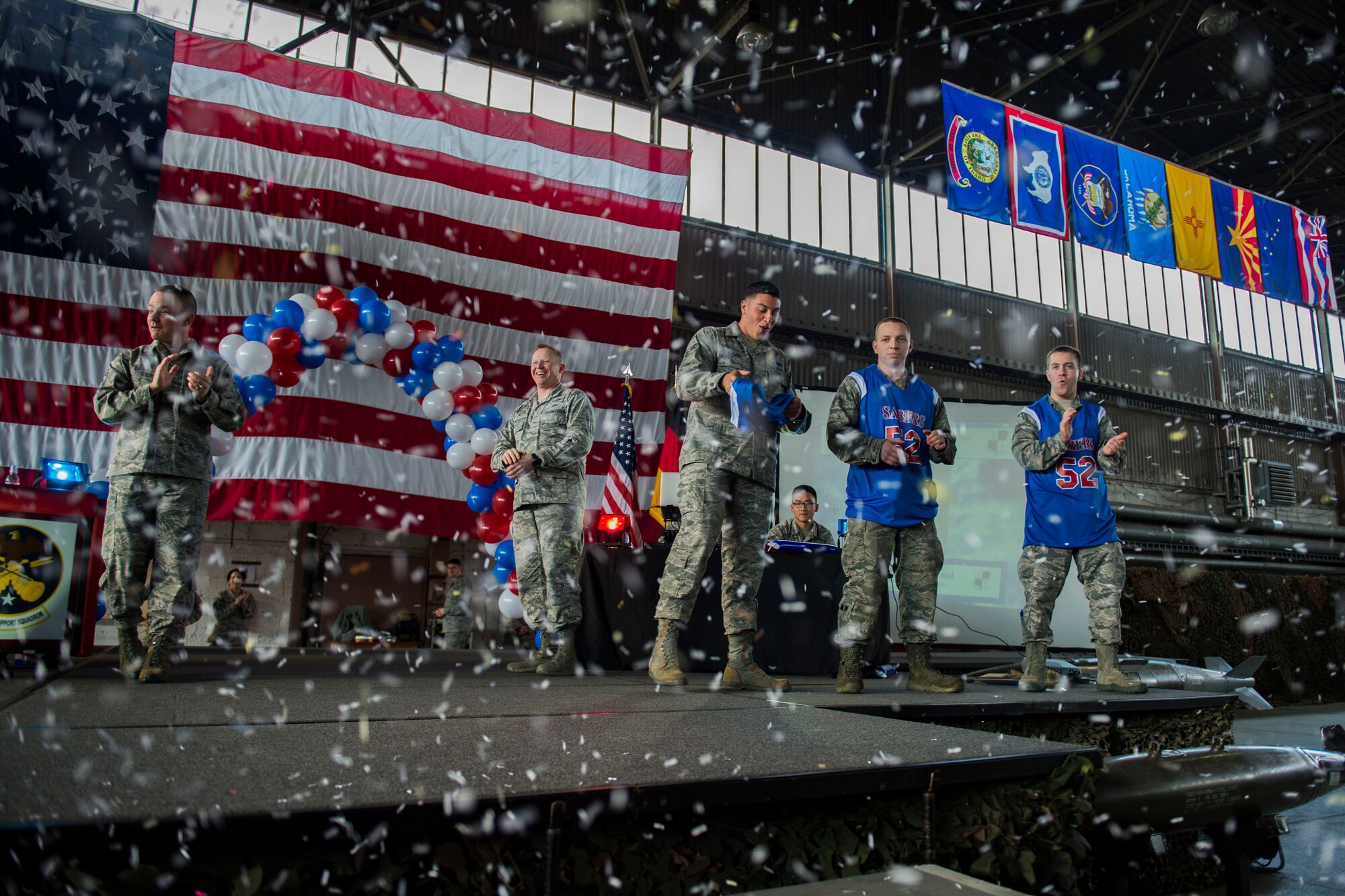 Spangdahlem Airmen cheer as some of the 52nd Fighter Wing 2015 annual awards nominees are recognized on stage at the Year in Review Pep Rally in Hangar 1 at Spangdahlem Air Base, Germany, Feb. 25, 2016. The annual awards winners will be announced at the Annual Awards Banquet at Club Eifel, Feb. 26, 2016. (U.S. Air Force photo by Airman 1st Class Luke Kitterman/Released)