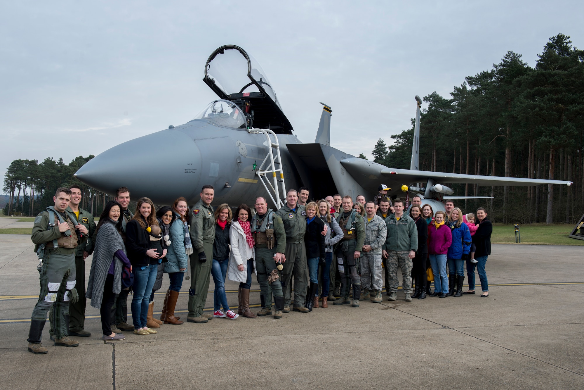 Lt. Col. John Stratton, 493rd Fighter Squadron commander, poses with his wife, friends and fellow Airmen after reaching his 2,000-hour flying milestone in the F-15C Eagle at Royal Air Force Lakenheath, England, Feb. 26, 2016. Col. Robert Novotny, 48th Fighter Wing commander presented Stratton with his 2,000-hour flying patch. The two have known each other since Stratton was a captain. (U.S. Air Force photo/Airman 1st Class Erin R. Babis)