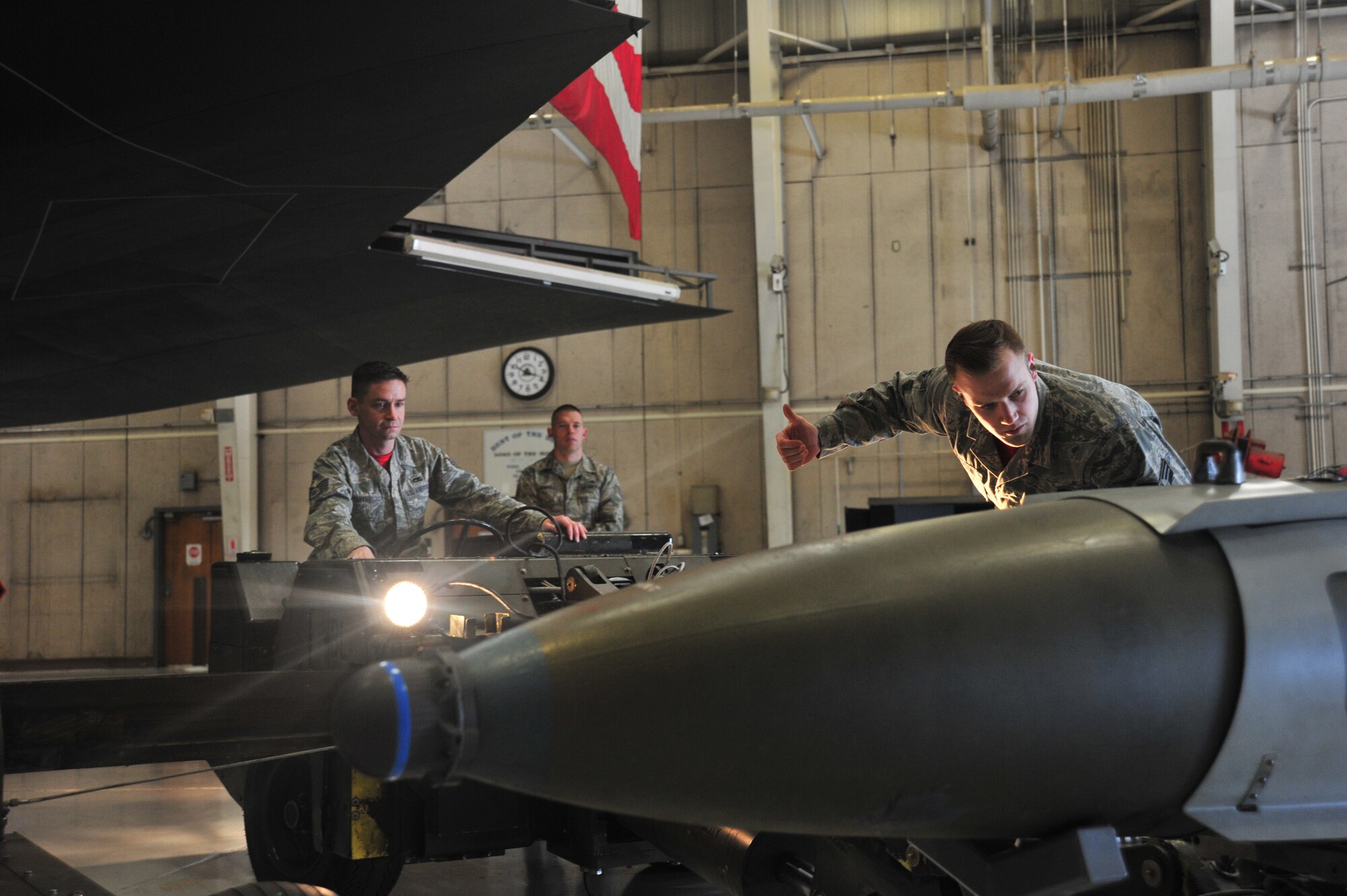 U.S. Air Force Senior Airman John Anderson, right, directs Staff Sgt. Jake Smith, both load crew members of the 131st Aircraft Maintenance Unit, as a trainer weapon is loaded onto a jammer during the annual Weapons Load Competition at Whiteman Air Force Base, Mo., Feb. 19, 2016. Load crew competitions help Airmen maintain their mission-readiness, ensuring they can perform at any given time. 