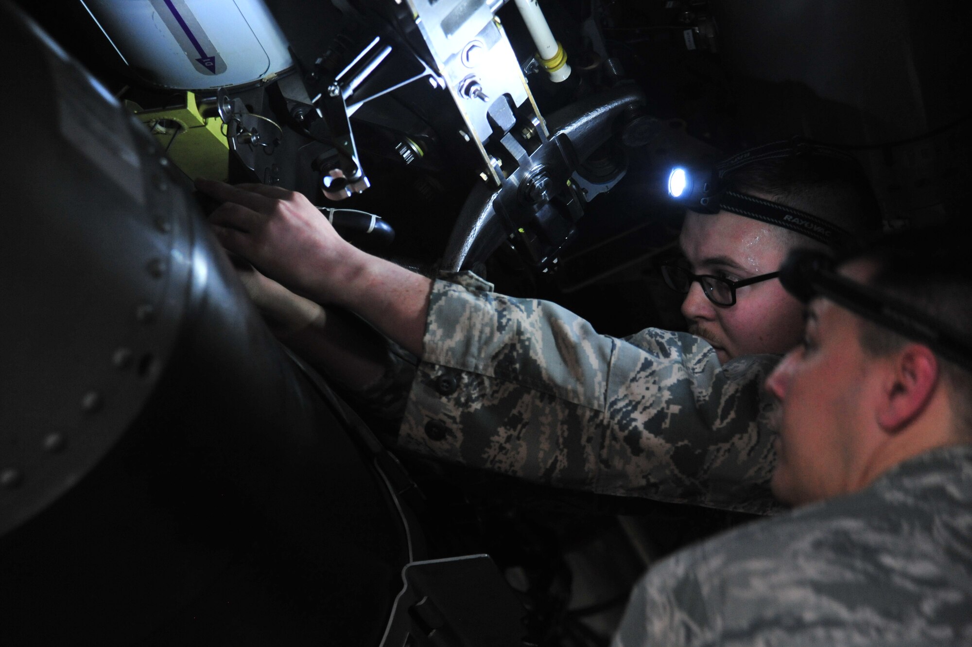 U.S. Air Force Tech. Sgt. Daniel Jensen, a load crew member assigned to the 131st Aircraft Maintenance Unit, secures the final trainer weapon for his team during the Annual Weapons Load Competition at Whiteman Air Force Base, Mo., Feb. 19, 2016. Each team must load two trainer weapons in addition to restocking all equipment before time is called.  