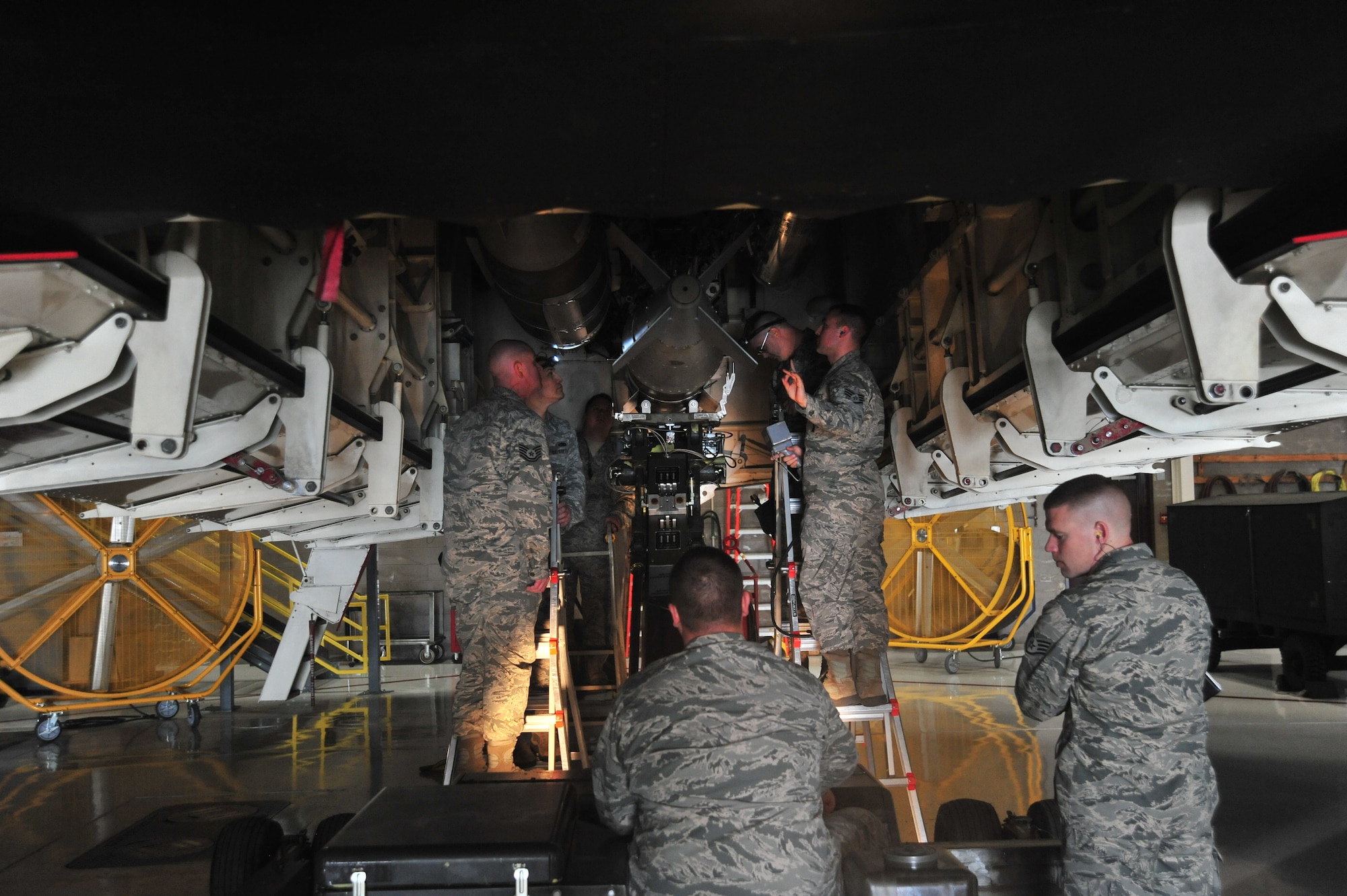 Load crew members of the 131st Aircraft Maintenance Unit load training munitions during the Annual Weapons Load Competition at Whiteman Air Force Base, Mo., Feb. 19, 2016. The load crews participating in the annual competition are crews who previously won a quarterly competition. 