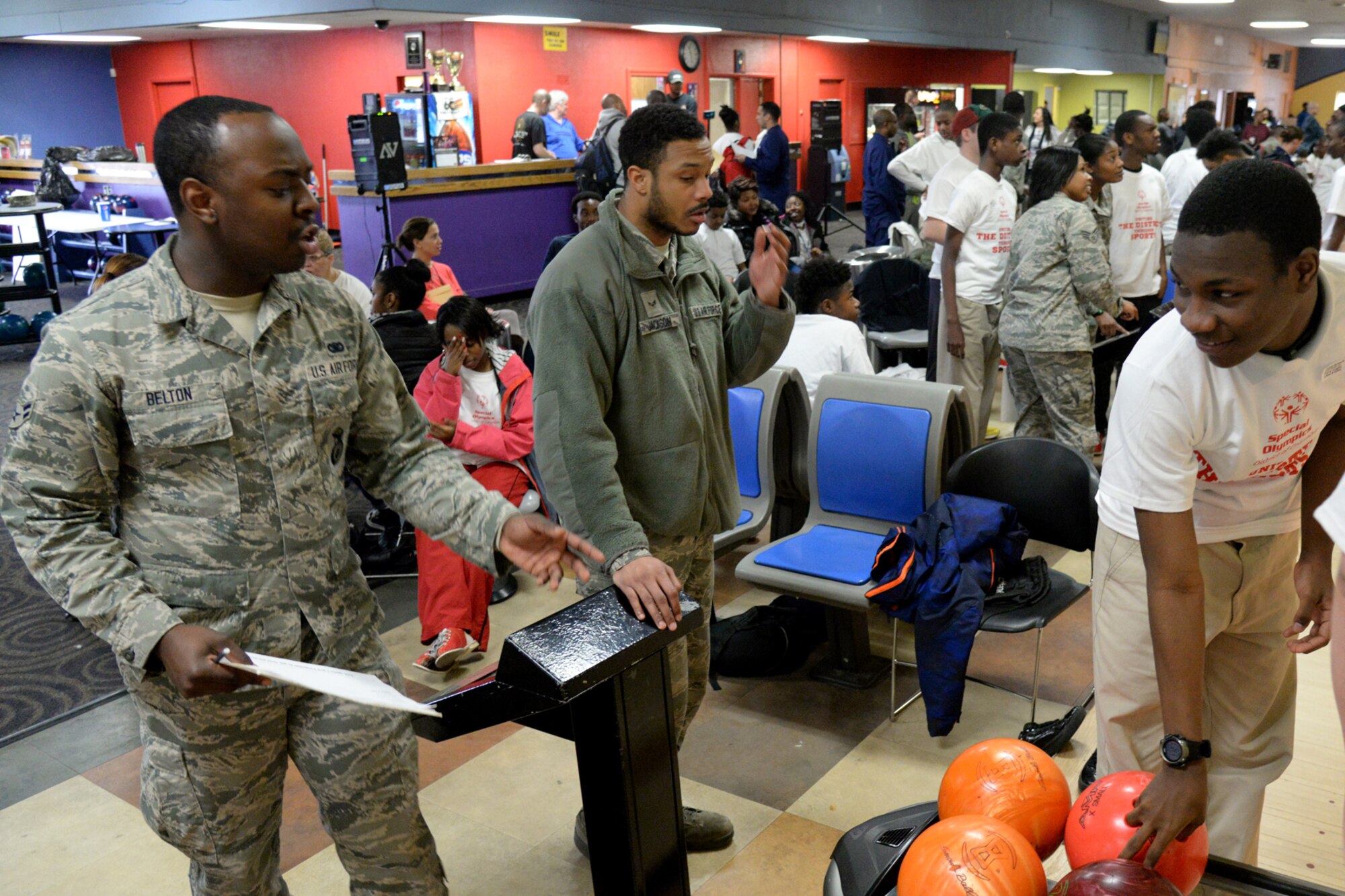 Airman 1st Class Jermaine Belton, 11th Security Forces Squadron assists an athlete during the D.C. Special Olympics Bowling Championship in Hyattsville, Md., Feb. 25, 2016. More than 70 Airmen from across the National Capital Region volunteered to support athletes competing in the event. (U.S. Air Force photo/Tech. Sgt. Matt Davis).