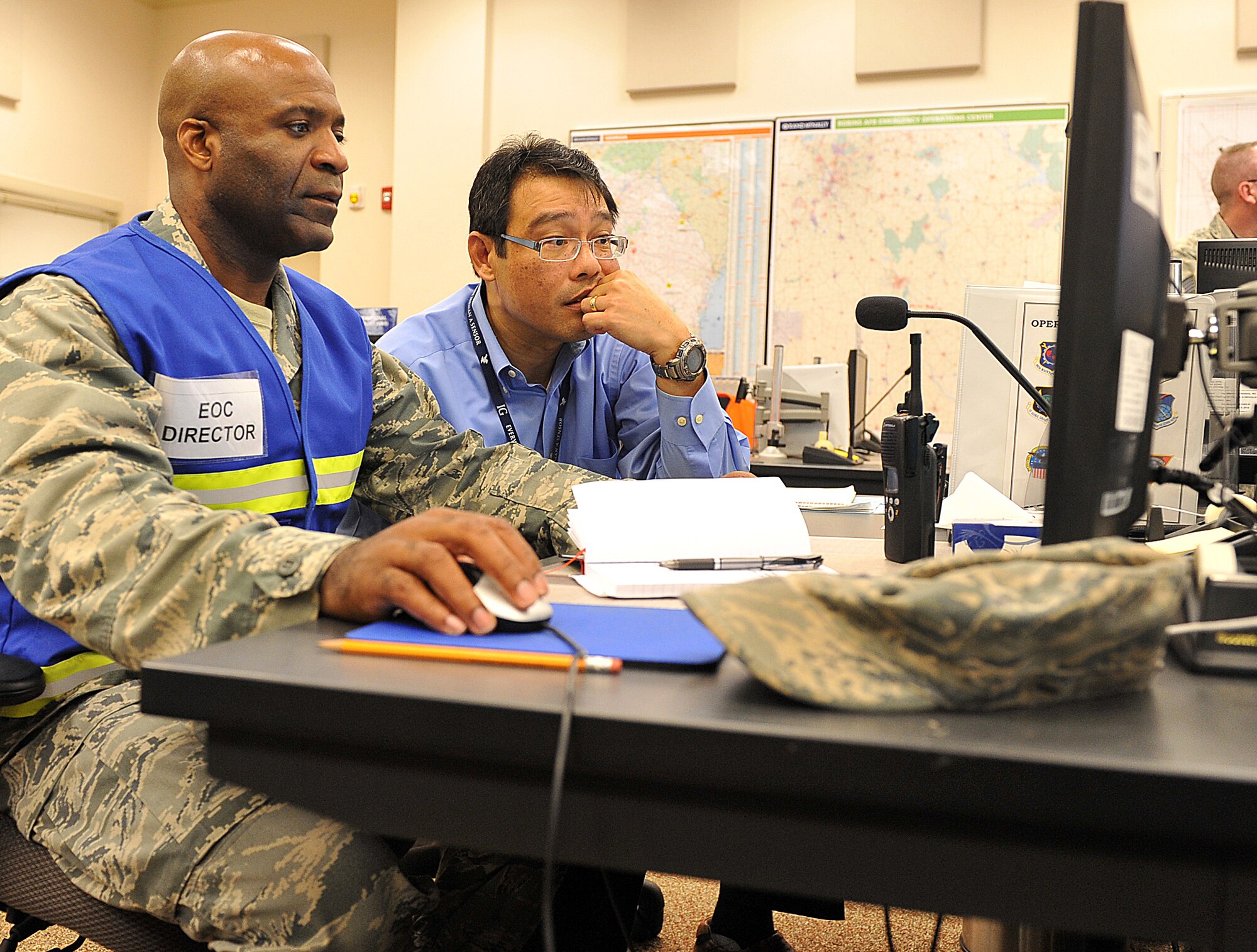 Col. Jarvis Baker, 78th Mission Support Group commander and Robins Emergency Operations Center director, and Mark Martinez, Installation Emergency manager, monitor emergency communication and coordination in the EOC which provides tactical response in the event of all types of disaster. A portion of this week’s exercise focused on natural disasters. (U.S. Air Force photo by Tommie Horton)