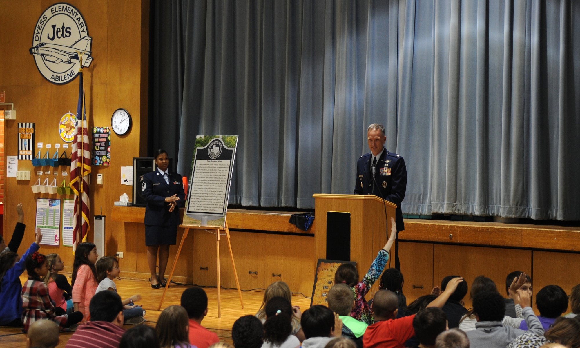 U.S. Air Force Col. Michael Miller, 7th Bomb Wing vice commander, speaks to students at Dyess Elementary Feb. 22, 2016, in Abilene, Texas. During a ceremony at Dyess Elementary, honoring it for being the first racially integrated school in Abilene, Miller communicated to students the importance of having a historical marker dedicated to their school and encouraged them to continue to be active in their community because they all have the potential to make a significant impact.  (U.S. Air Force photo by Senior Airman Shannon Hall/Released)