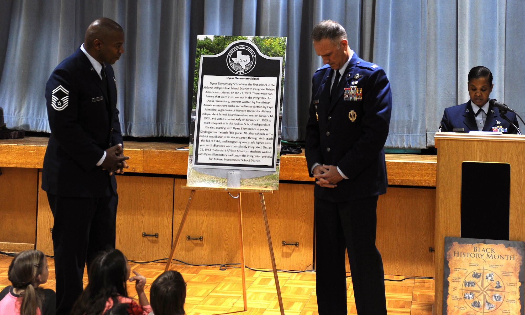 U.S. Air Force Col. Michael Miller, right, 7th Bomb Wing vice commander and Senior Master Sgt. Tremayne Hubbard, Dyess African-American Heritage committee president, unveil a historical marker Feb. 22, 2016, at Dyess Elementary in Abilene, Texas. In January 2015, Hubbard started researching integration in the Abilene Independent School District and applied for a historical marker to be placed at the elementary since it was the first school in Abilene ISD to become racially integrated in 1963. (U.S. Air Force photo by Senior Airman Shannon Hall/Released)