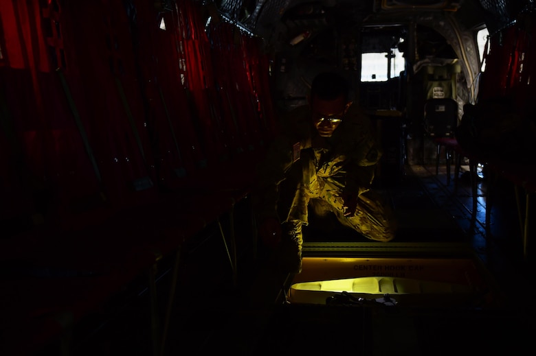U.S. Army Sgt. Benjamin Stocker, Colorado National Guard CH-47 flight engineer and mechanic, opens up the center cargo hook hatch Feb. 19, 2016, at the Army Aviation Support Facility on Buckley Air Force Base. The flight engineer can open the center cargo hook hatch during flight when a sling loads need to be adjusted. (U.S. Air Force photo by Airman 1st Class Gabrielle Spradling/Released)