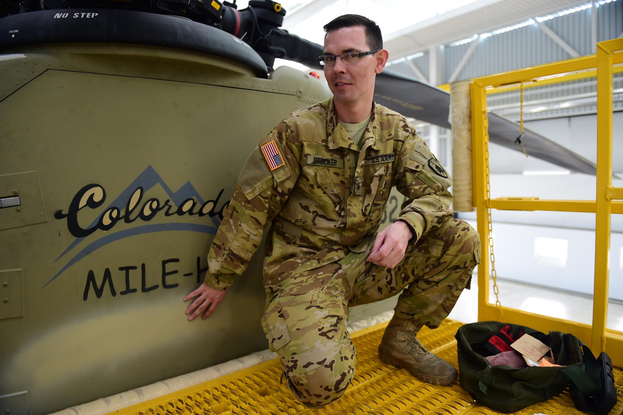 U.S. Army Sgt. Benjamin Stocker, Colorado National Guard CH-47 flight engineer and mechanic, sits next to his Ch-47 Chinook Feb. 19, 2016, at the Army Aviation Support Facility on Buckley Air Force Base.  As a Chinook mechanic Stocker maintained the aircraft, not only as a whole, but also the small details. (U.S. Air Force photo by Airman 1st Class Gabrielle Spradling/Released)