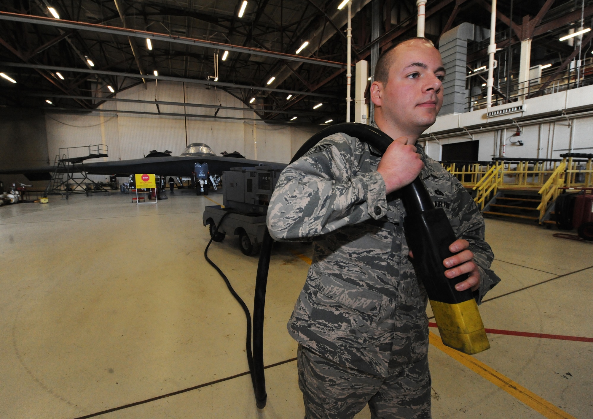 U.S. Air Force Tech Sgt. Aaron Bradley, a 393d Aircraft Maintenance Unit specialist section chief, prepares to supply power to a B-2 Spirit at Whiteman Air Force Base, Mo., Feb. 18, 2016. The power, provided by a generator, allows operation of the aircraft avionics system and is essential when working on the B-2’s landing gear. (U.S. Air Force photo by Tech. Sgt. Miguel Lara III) 