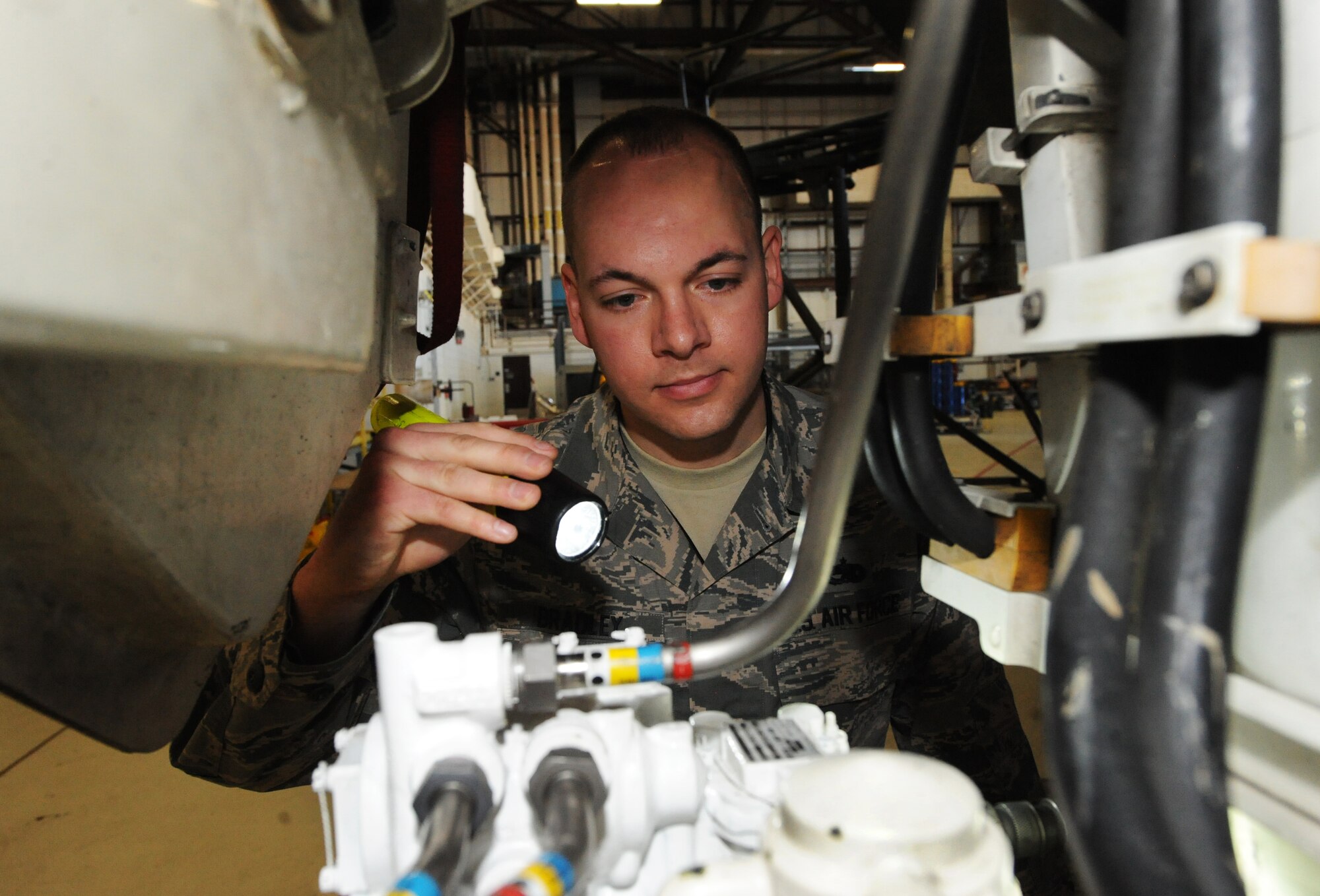 U.S. Air Force Tech Sgt. Aaron Bradley, a 393d Aircraft Maintenance Unit specialist section chief, inspects the hydraulic lines of a B-2 Spirit at Whiteman Air Force Base, Mo., Feb. 18, 2016. The inspection of the 4,000 psi hydraulic system tests operation of the B-2 flight controls, landing gear, brakes, steering and weapon systems. (U.S. Air Force photo by Tech. Sgt. Miguel Lara III)