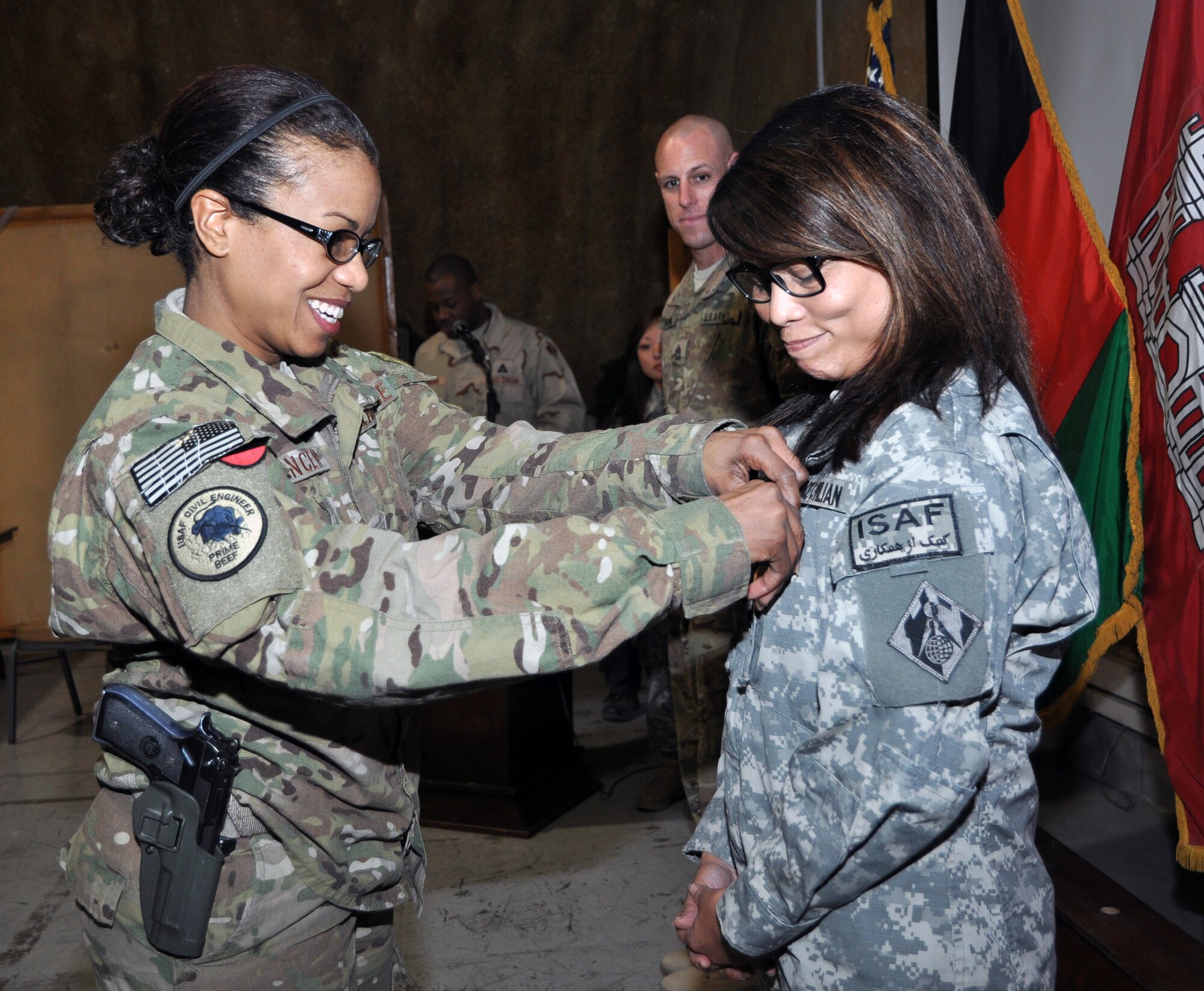 Air Force Lt.Col. Yvonne S. Spencer, district deputy commander, presents an award to Sai Shasrp in Kabul, Afghanistan during a Transatlantic District North house meeting. (Official USACE photo/M. Beeman)