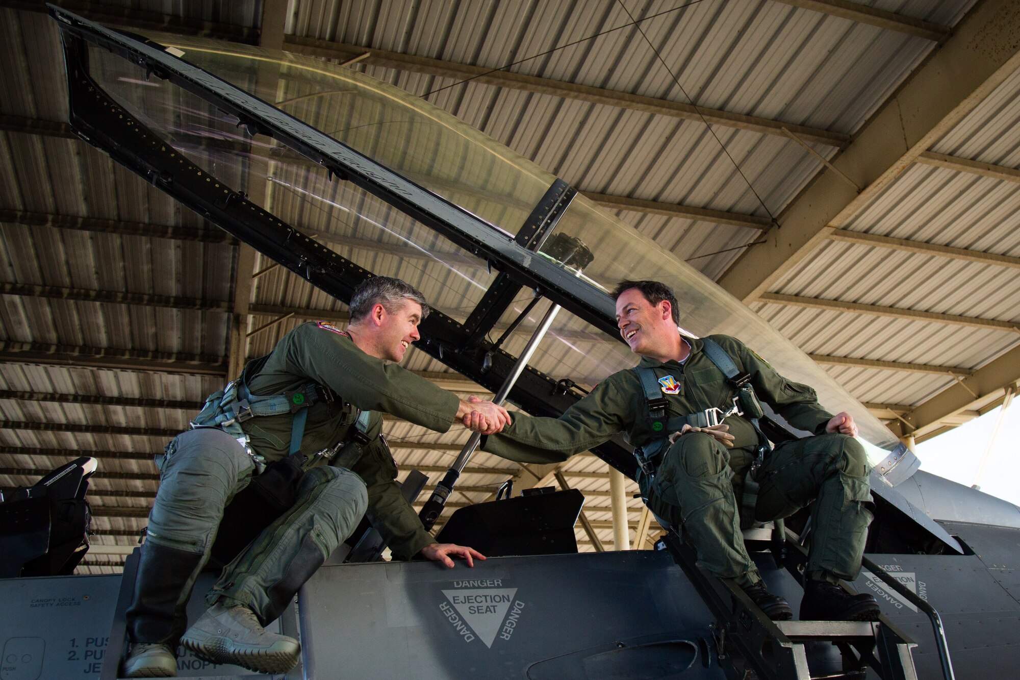 Lt Col Ed Casey, 100th Fighter Squadron Director of Operations, shakes hands with Pastor Chris Hodges, senior pastor at Church of the Highlands, after Hodges' orientation flight. Hodges shared his experience with thousands of his social media followers and members of his congregation, spreading awareness of the 187th Fighter Wing mission. (Courtesy photo, Church of the Highlands/Released). 