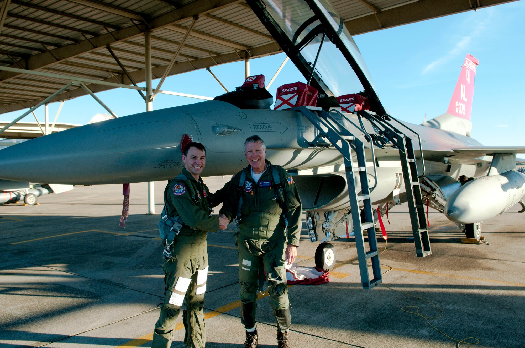 Lt Col Mike McGinn, 100th Fighter Squadron Commander, poses with Billy Strickland, a local business owner, after Strickland’s orientation flight February 18, 2016. Orientation flights inform local leaders about the 187th Fighter Wing mission and can increase awareness of the wing in the community. (U.S. Air National Guard photo by Senior Airman Jared Rand/Released.)