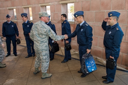 U.S. Air Force Maj. Gen. Ed Wilson (center), 24th Air Force and Air Forces Cyber Command (AFCYBER) commander shakes hands with Turkish Air Force Lt. Col. Hasan Cifci, Head of Cyber Defense Command and member of a Turkish Air Force cybersecurity delegation during their visit to Headquarters, 24AF - AFCYBER, Joint Base San Antonio - Lackland, Texas, Feb 23. The delegation visit was centered upon strengthening U.S. and allied forces partnerships as well as to gain further insight on how 24AF - AFCYBER organizes, trains, equips, and tasks our cyber forces. (U.S. Air Force photo by Master Sgt. Luke P. Thelen/Released)