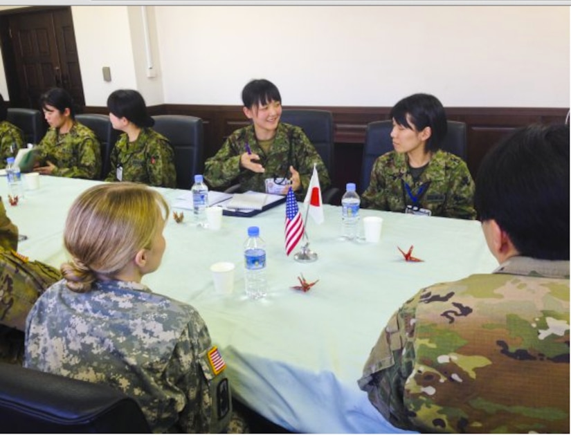 A Japan Ground Self-Defense Force junior noncommisioned officer explains how their promotion system works during a bilateral exchange at Camp Itami, Japan, Dec. 5, 2015.