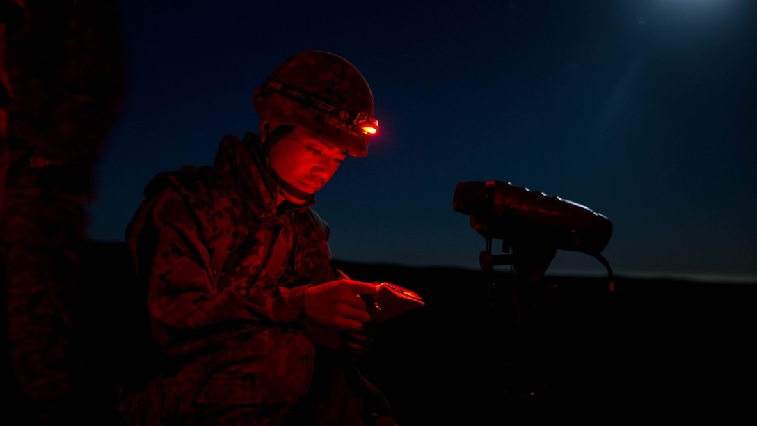 A soldier with Western Army Infantry Regiment, Japan Ground Self-Defense Force, reviews fire mission calls during a supporting arms coordination center (SACCEX) exercise at San Clemente Island, Feb. 21, 2016, as part of Exercise Iron Fist 2016. The SACCEX serves as a cooperative learning tool for the US-Japan partnership through the operation of a supporting arms coordination center, which has developed the USMC and JGSDF’s ability to integrate naval gunfire, mortars and close-air support  as a combined force.