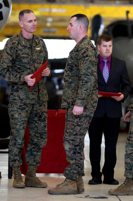 Sergeant Eric Foldvary prepares to receive a certificate from Maj. Gen. Gary L. Thomas after completing the Squadron Intelligence Training and Certification Course at Mid Atlantic Electronic Warfare Range, N.C., Feb. 12, 2016. To date, the course has certified more than 300 Marines enabling them to better integrate into the Marine Air-Ground Task Force. Thomas is the commanding general of 2nd MAW, Foldvary is an intelligence specialist with Marine Aircraft Group 14. (U.S. Marine Corps photo by Cpl. Jason Jimenez/Released)