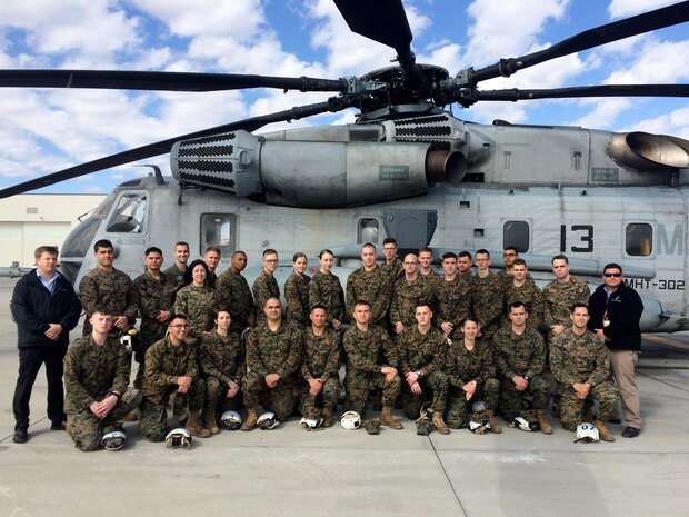 Instructors and students pose for a photo in front of a CH-53E Super Stallion during a Squadron Intelligence Training and Certification Course at Marine Corps Air Station New River, N.C., Feb. 12, 2016. The course combines classroom instruction as well as intense student intelligence evaluation and briefing requirements followed by practical application events in direct support of live aviation requirements.  (Photo by Timothy D. Andres/Released)