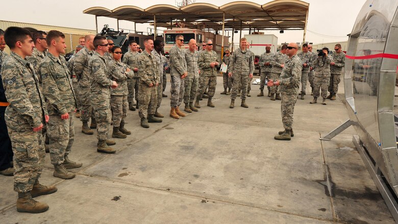 Maj. Sam, 380th Expeditionary Maintenance Squadron commander, talks about the combined effort to create the fire department’s new search and rescue aircraft trainer during a ribbon-cutting ceremony at an undisclosed location in Southwest Asia, Feb. 19. The project, something that had never been done by Fabrication Flight, gave the Airmen an opportunity to be creative, without the aid of blue prints. (U.S. Air Force photo by Staff Sgt. Kentavist P. Brackin/released)