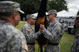 Brig. Gen. Jose R. Burgos passes the flag to Maj. Gen. David J. Conboy, relinquishing his command and gratitude for the opportunity to lead Soldiers of the 1st Mission Support Command during a change of command ceremony at Maxie Williams Field, Fort Buchanan, Puerto Rico, Feb. 27. (U.S. Army Photo by Spc. Anthony Martinez)