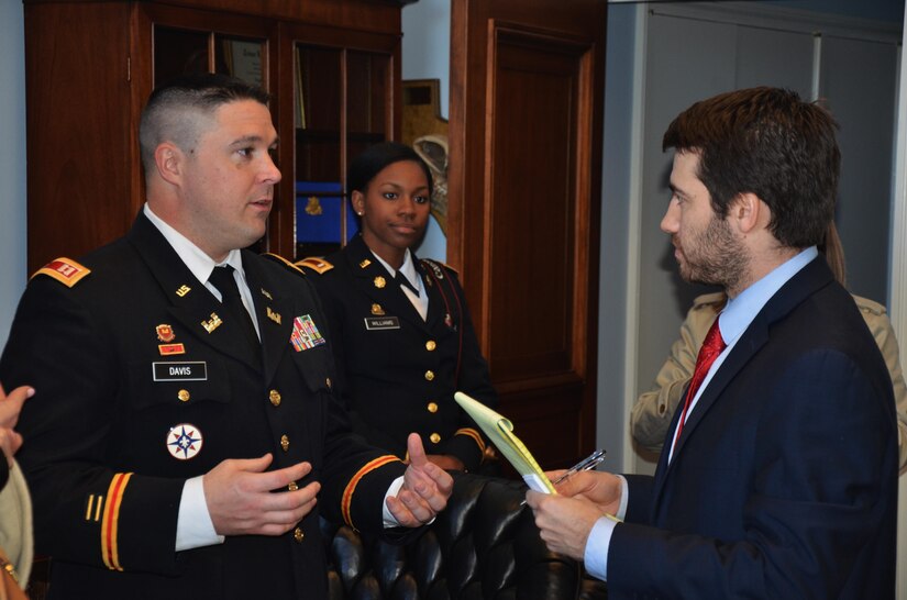 Capt. Michael Davis, commander, assigned to Forward Support Company, 980th Engineer Battalion, speaks with Doug Molof, Senior Legislative Assistant to Congressman Lloyd Doggett (D-TX-35) during a tour of Washington. Davis and fellow members of the unit’s Family Readiness Group had the opportunity to visit offices of their home state representatives of Texas after receiving the 2015 Department of Defense Reserve Family Readiness Award during a ceremony at the Pentagon Hall of Heroes, Feb. 26, as the best FRG in the Army Reserve.