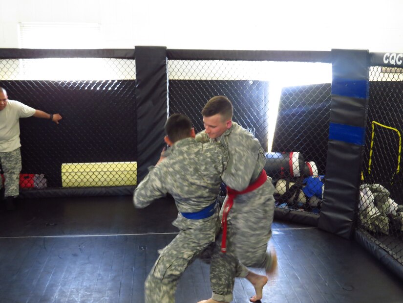 U.S. Army Spc. Cameron Olney and Spc. Bryan Hernandez, Soldiers with the 4th Sustainment Command (Expeditionary) face off in combatives during the 2016 4th ESC Best Warrior Competition at Joint Base San Antonio, Feb. 19, 2016. (U.S. Army Photo by Sgt. 1st Class Larry Franklin/Released)