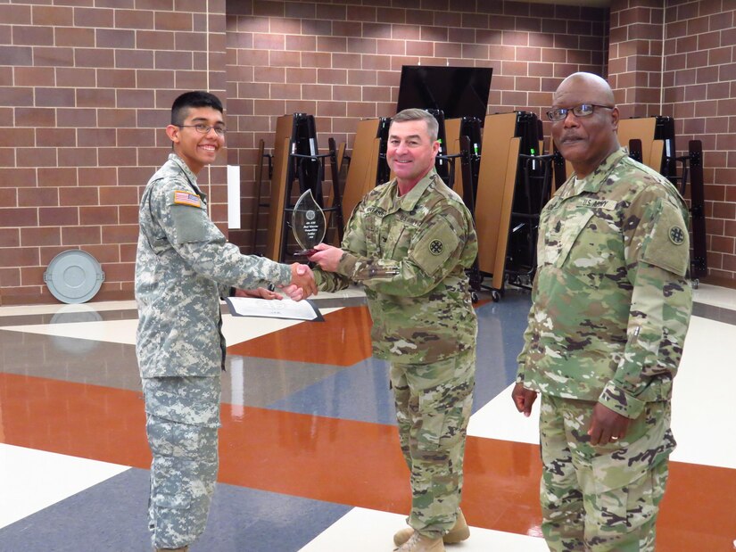 U.S. Army Spc. Matthew Nunez, Soldier with the 851st Transportation Company, 319th Combat Sustainment Support Battalion, 211th Regional Support Group, 4th Sustainment Command (Expeditionary) (ESC) receives a plaque for winning the 2016 Best Warrior Competition from Col. John A. Fontana the 4th ESC mission support element(MSE) Chief of Staff and Command Sgt. Maj. Larry D. Johnson, the 4th ESC MSE command sergeant major at Joint Base San Antonio, Feb. 21, 2016. (U.S. Army Photo by Capt. Jose L. Caballero Jr./Released)