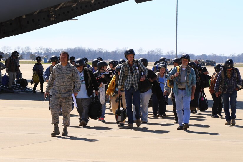 Evacuees from Dara Lam, the provincial capital of Atropia located within the Joint Readiness Training Center exercise, move to the Intermediate Stage Base on Feb. 18, as part of a role play exercise for the 103rd Quartermaster Company to verify and identify local citizens. This evacuee operation exercise helps Soldiers to partner with consulates from the State Department and simulate real world situations that Soldiers may have to encounter in the future. (U.S. Army Reserve Photo by Sgt. Bethany L. Huff)