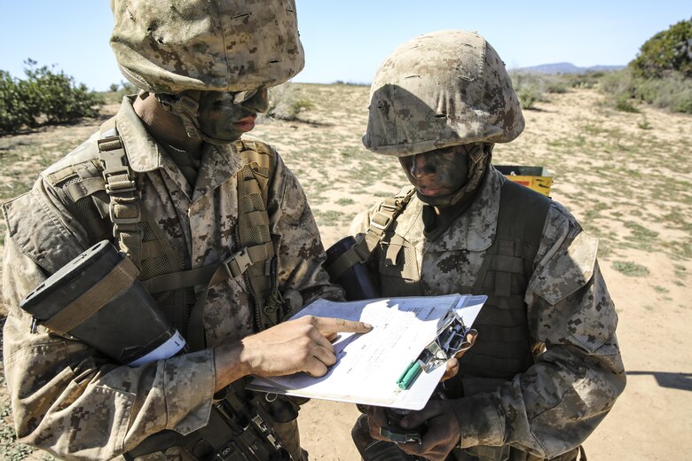 Recruits of Echo Company, 2nd Recruit Training Battalion, confirm they’re going the correct direction during the Land Navigation Course at Edson Range, Marine Corps Base Camp Pendleton, Calif., Feb. 24. Recruits will use these skills taught when they continue their training at the School of Infantry. Annually, more than 17,000 males recruited from the Western Recruiting Region are trained at MCRD San Diego. Echo Company is scheduled to graduate March 4.