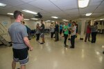 160131-N-BR087-005 PHILIPPINE SEA(Jan. 31, 2016) - Electrician's Mate 2nd Class Patrick Dent, from Cape Coral, Fla., instructs Sailors during a swing dancing class in USS John C. Stennis' (CVN 74) Training Resource Complex. Providing a ready force supporting security and stability in the Indo-Asia-Pacific, Stennis is operating as part of the Great Green Fleet on a regularly scheduled 7th Fleet deployment. (U.S. Navy photo by Mass Communication Specialist Seaman Cole C. Pielop / Released)