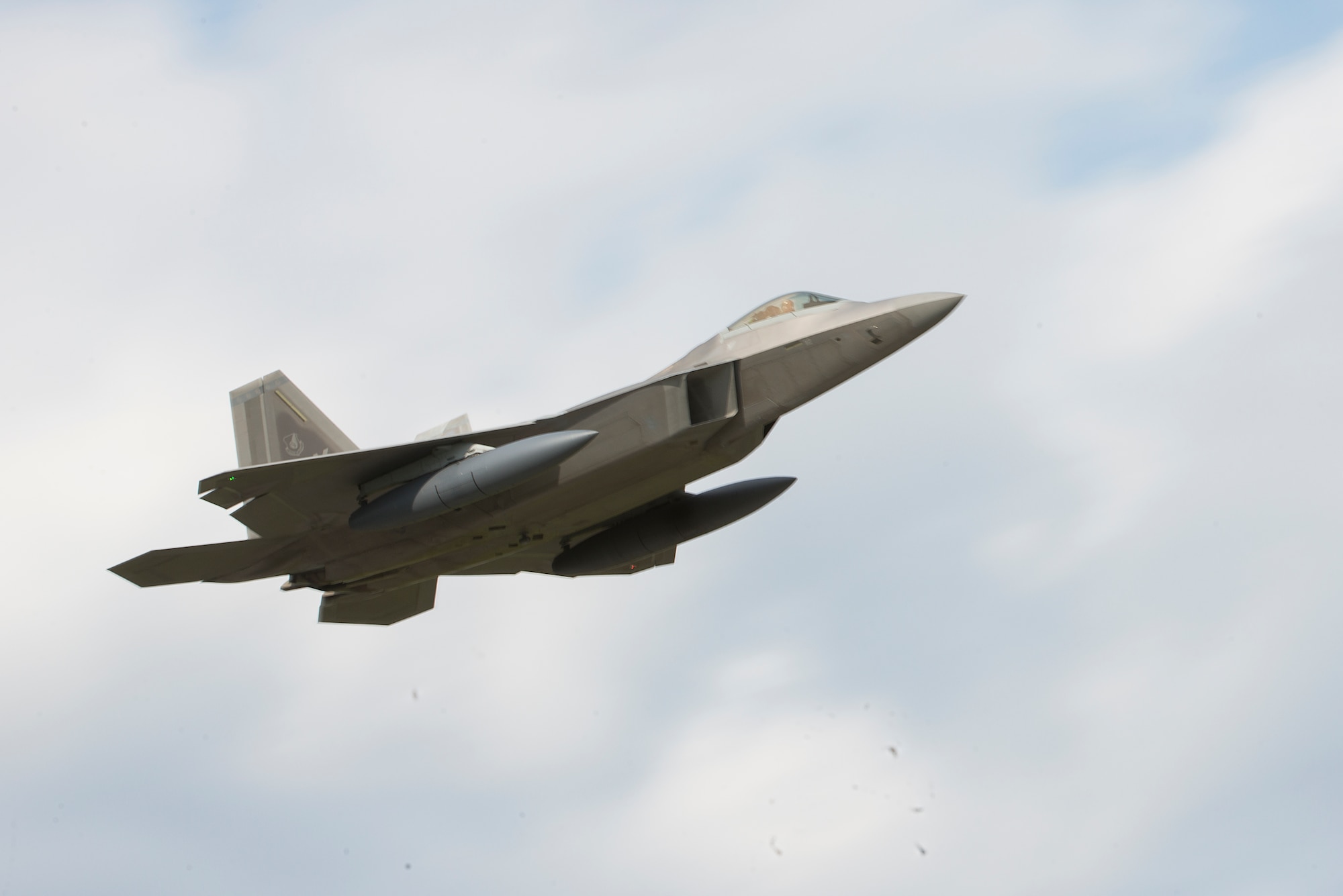 A U.S. Air Force F-22 Raptor from the 525th Fighter Squadron flies over Kadena Air Base, Japan, after takeoff before heading to the Republic of Korea Feb. 17, 2016. Four Raptors from the 525th FS conducted a combined formation flight alongside Republic of Korea F-15K Slam Eagles and U.S. Air Force F-16 Fighting Falcons in the vicinity of Osan Air Base, South Korea, to demonstrate the capabilities of the ROK-U.S. Alliance Feb. 17. The 525th FS is stationed at Joint Base Elmendorf-Richardson, Alaska. (U.S. Air Force photo by Staff Sgt. Maeson L. Elleman)