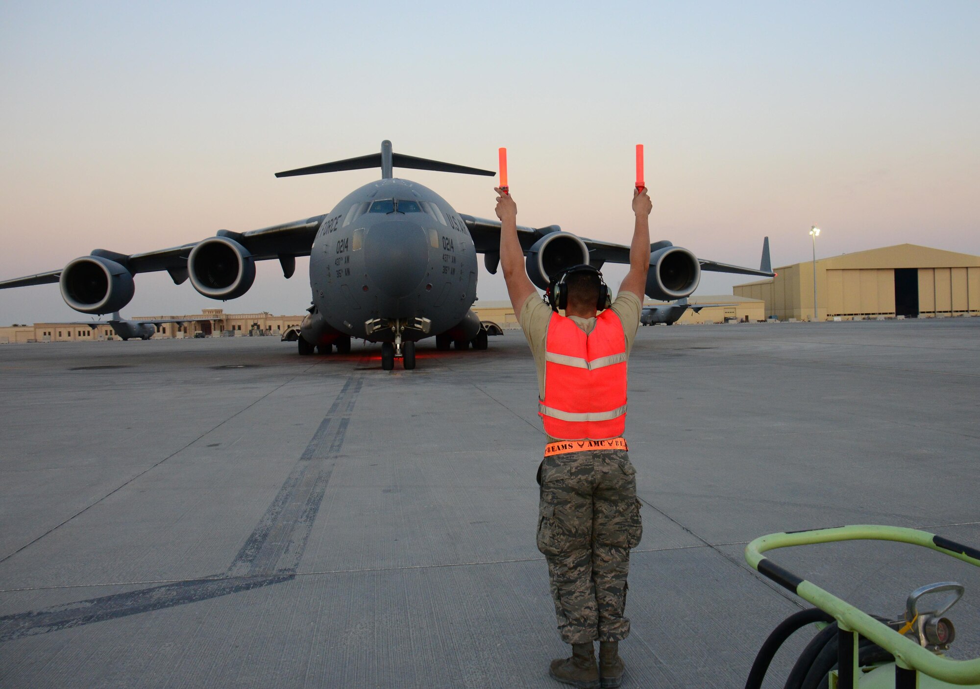 Airman 1st Class Jacob Chambers, 8th Expeditionary Air Mobility Squadron C-17 Globemaster III crew chief, from Natichitoches, Louisiana, marshals in a C-17 Globemaster III at Al Udeid Air Base, Qatar Feb. 19. The 8 EAMS maintenance team performs maintenance actions on C-17 aircraft to ensure they’re mission ready. (U.S. Air Force photo by Tech. Sgt. James Hodgman/Released)