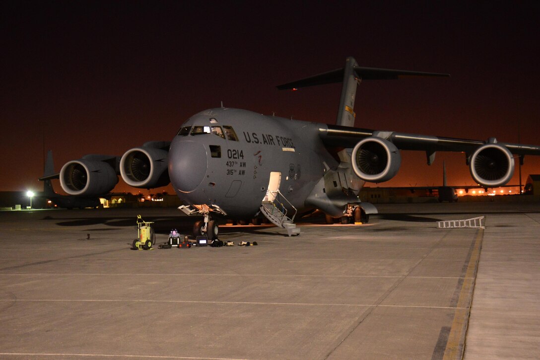 A C-17 Globemaster III from Joint Base Charleston, South Carolina undergoes maintenance in the evening at Al Udeid Air Base, Qatar Feb. 19. The C-17 fleet at AUAB is maintained by the 8th Expeditionary Air Mobility Squadron maintenance team. The team performs maintenance actions on C-17 aircraft to ensure they’re mission ready. (U.S. Air Force photo by Tech. Sgt. James Hodgman/Released)

