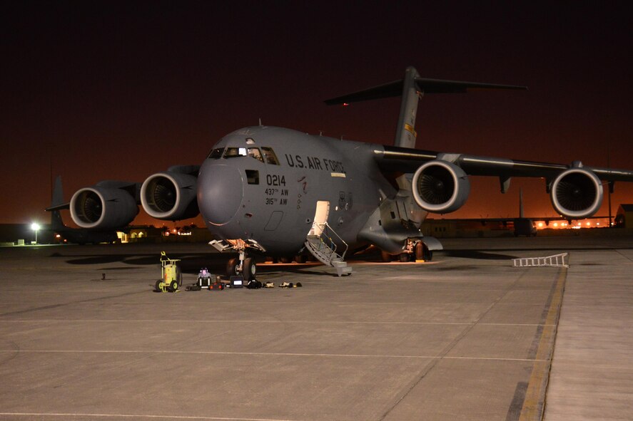 A C-17 Globemaster III from Joint Base Charleston, South Carolina undergoes maintenance in the evening at Al Udeid Air Base, Qatar Feb. 19. The C-17 fleet at AUAB is maintained by the 8th Expeditionary Air Mobility Squadron maintenance team. The team performs maintenance actions on C-17 aircraft to ensure they’re mission ready. (U.S. Air Force photo by Tech. Sgt. James Hodgman/Released)

