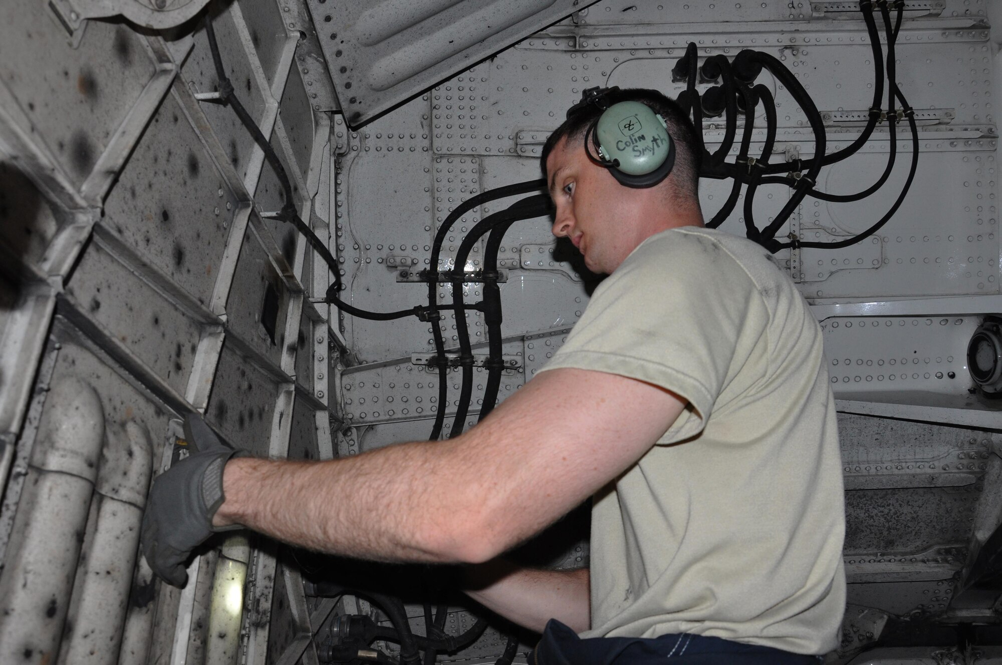 Senior Airman Colin Smyth, 8th Expeditionary Air Mobility Squadron C-17 Globemaster III crew chief, from Lake Geneva, Wisconsin, inspects the landing gear of a C-17 at Al Udeid Air Base, Qatar Feb. 19. The 8 EAMS maintenance team performs maintenance actions on C-17 aircraft to ensure they’re mission ready. (U.S. Air Force photo by Tech. Sgt. James Hodgman/Released)