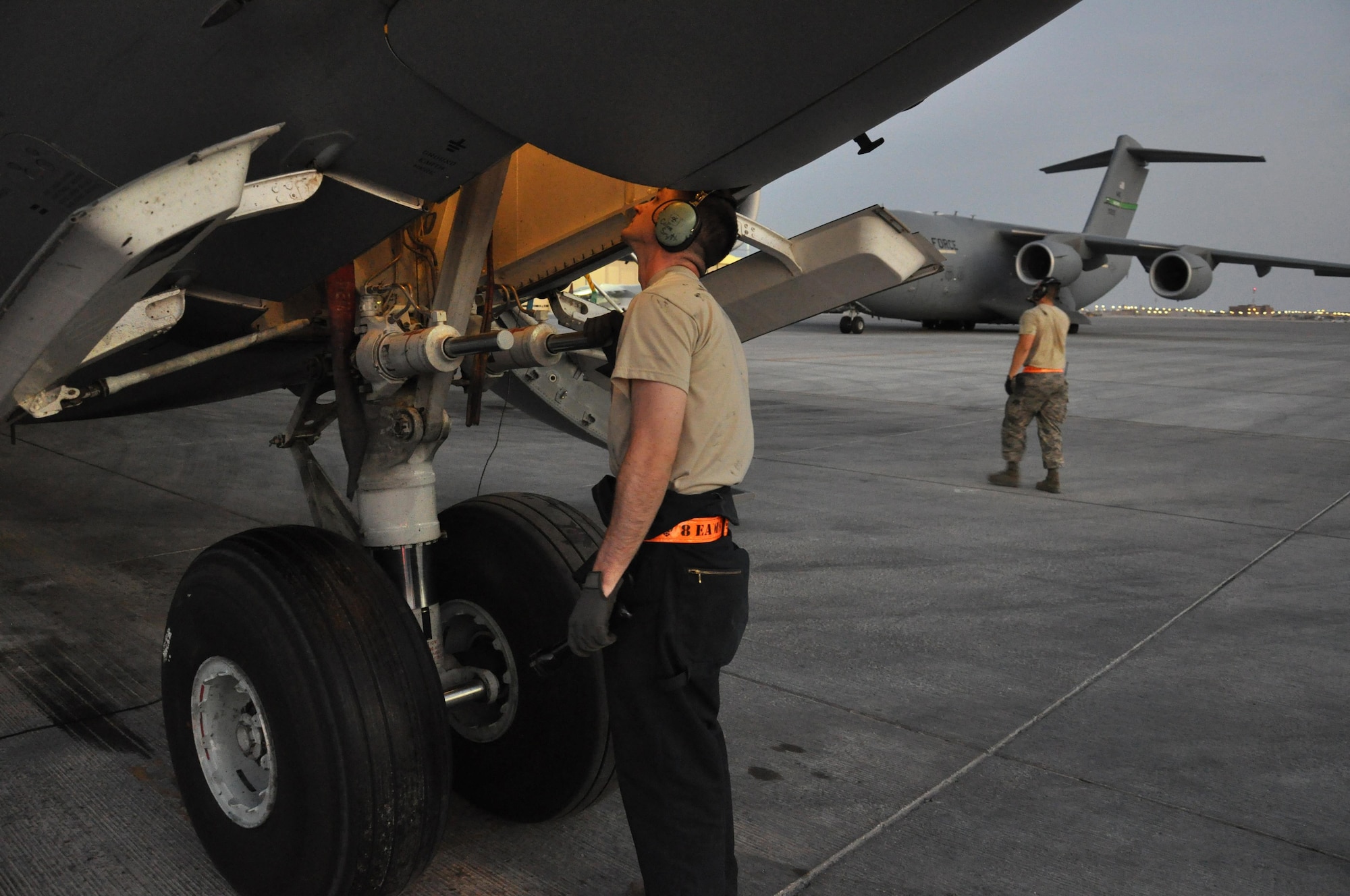 Senior Airman Colin Smyth, 8th Expeditionary Air Mobility Squadron C-17 Globemaster III crew chief, from Lake Geneva, Wisconsin, inspects the landing gear of a C-17 at Al Udeid Air Base, Qatar Feb. 19. The 8 EAMS maintenance team performs maintenance actions on C-17 aircraft to ensure they’re mission ready. (U.S. Air Force photo by Tech. Sgt. James Hodgman/Released)