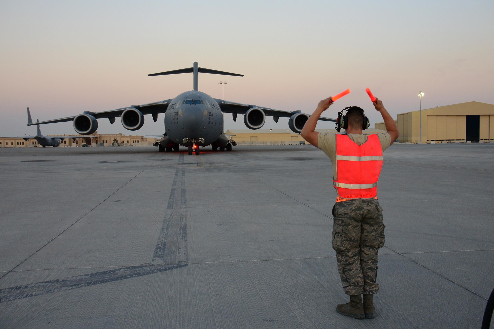 Airman 1st Class Jacob Chambers, 8th Expeditionary Air Mobility Squadron C-17 Globemaster III crew chief, from Natichitoches, Louisiana, marshals in a C-17 Globemaster III at Al Udeid Air Base, Qatar Feb. 19. The 8 EAMS maintenance team performs maintenance actions on C-17 aircraft to ensure they’re mission ready. (U.S. Air Force photo by Tech. Sgt. James Hodgman/Released)